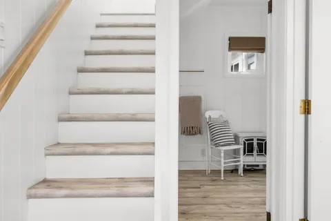 a view of entryway and hall with wooden floor