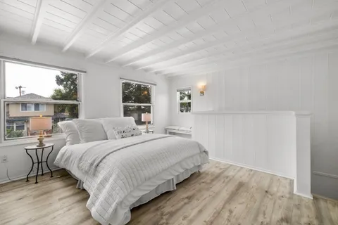 a bedroom with a large bed and a large window