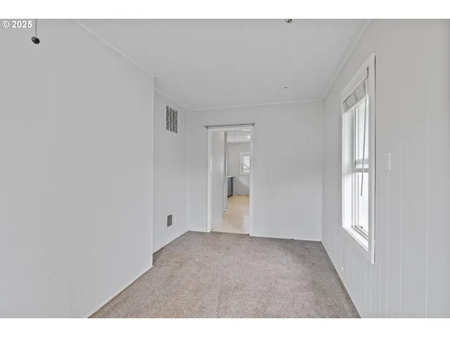 a view of an empty room and a window