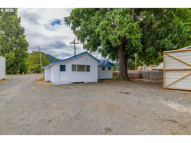 a view of a house with a yard and garage
