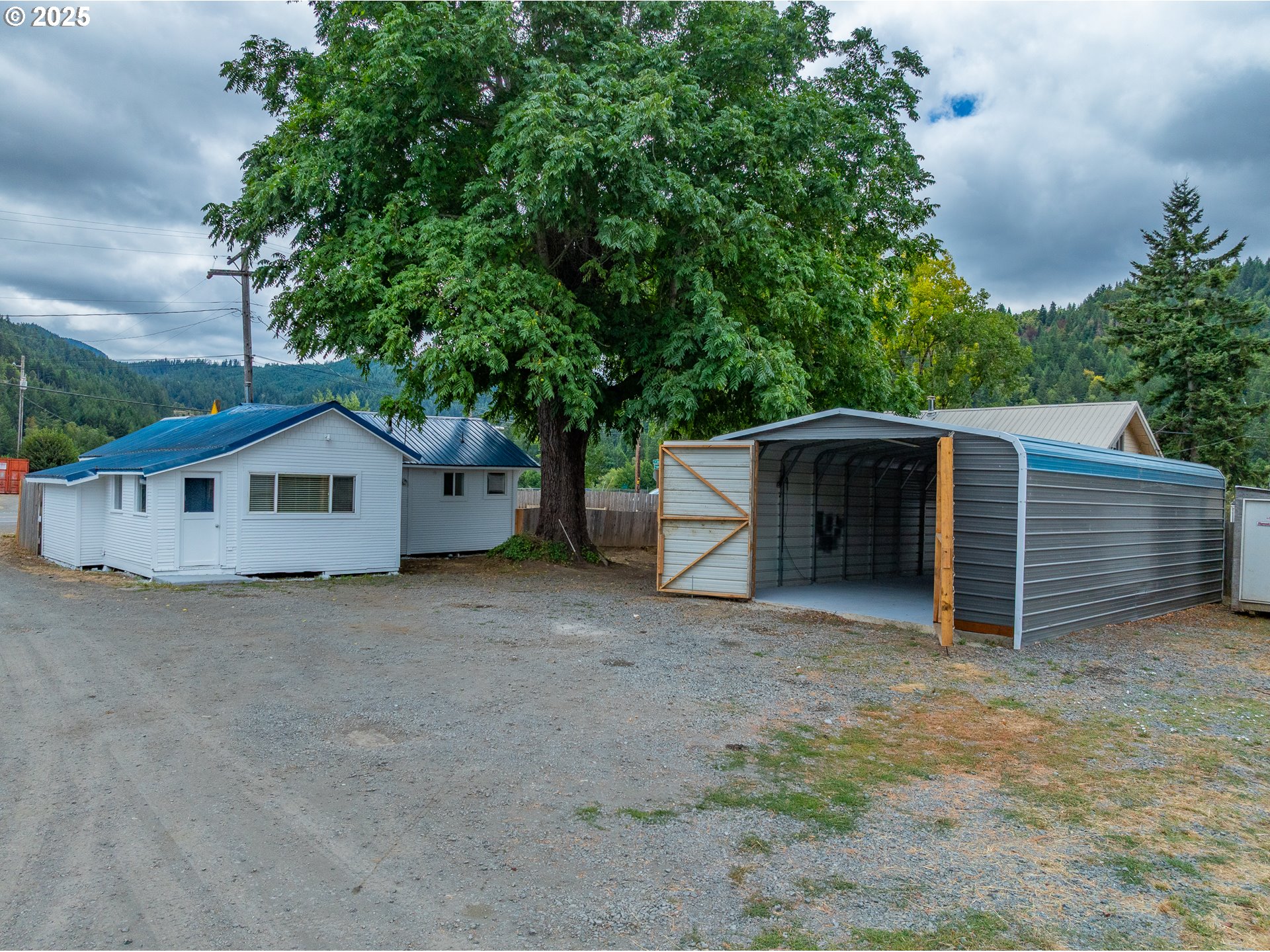 141 Poplar Street Powers, OR 97466 - Photo 26 of 37 a view of a house with a yard and large tree