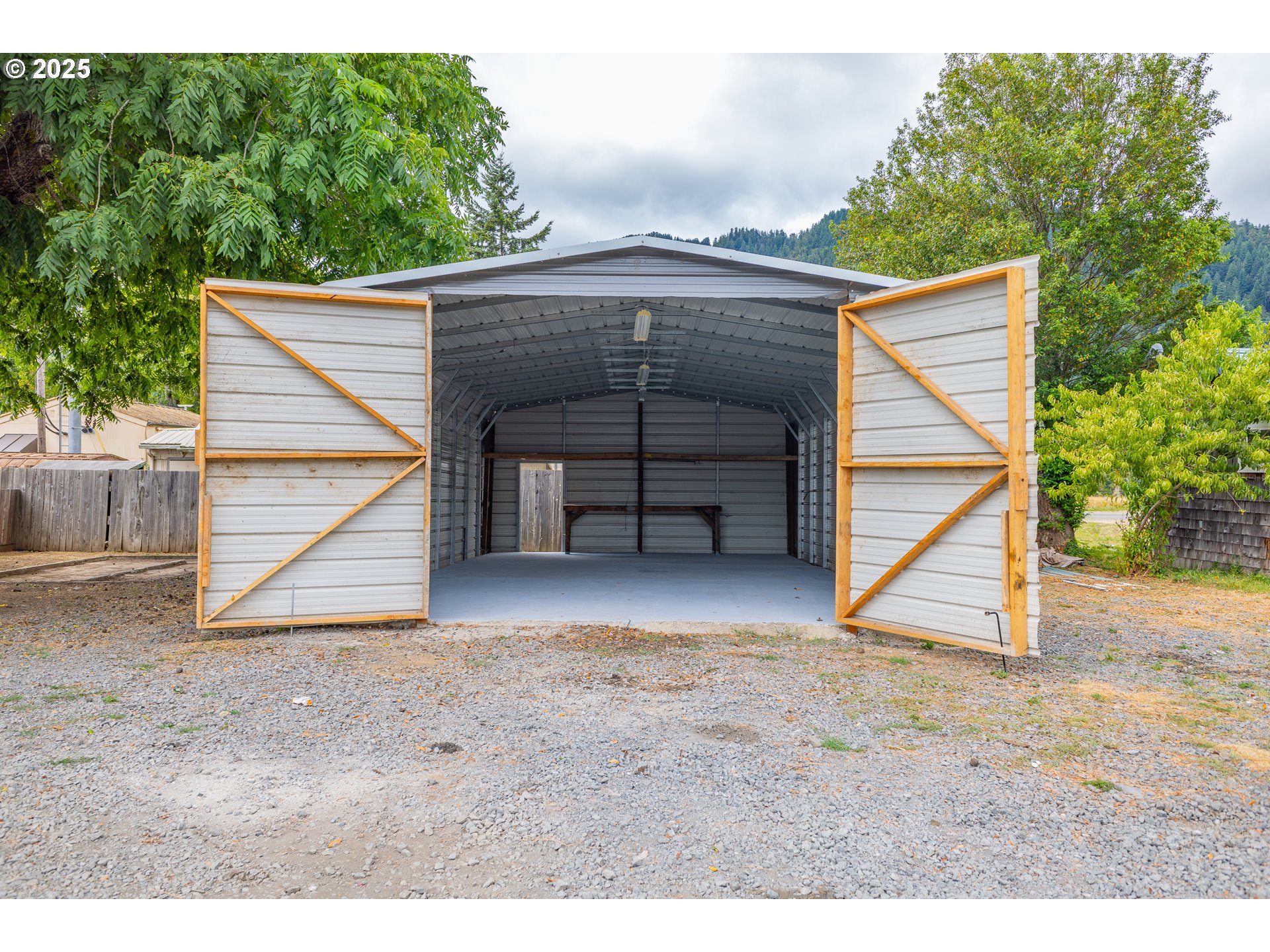 141 Poplar Street Powers, OR 97466 - Photo 27 of 37 a view of a house with a yard and garage