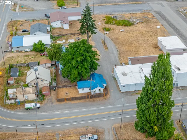 an aerial view of a house with a swimming pool outdoor seating and yard