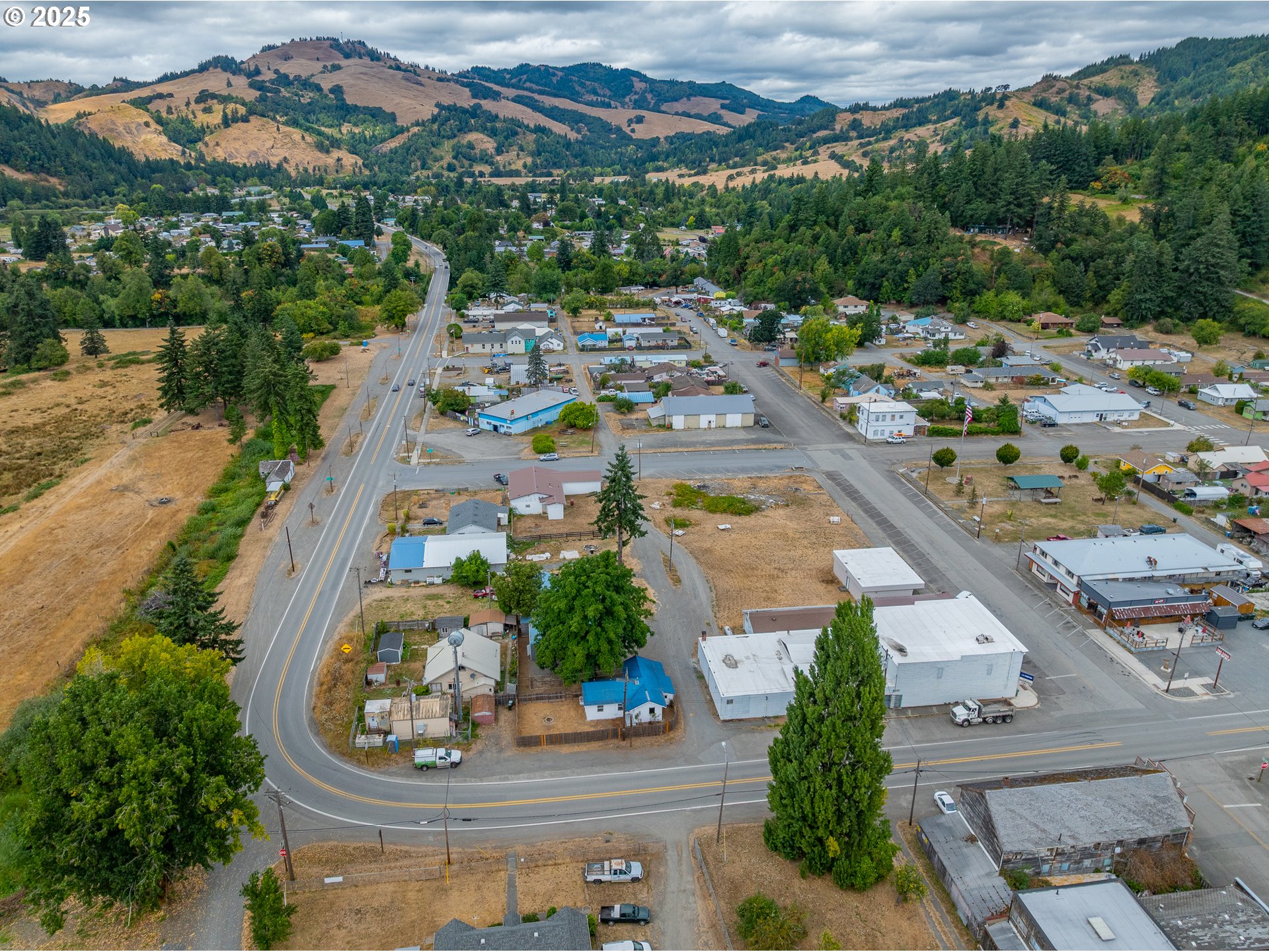 141 Poplar Street Powers, OR 97466 - Photo 37 of 37 an aerial view of a house with a swimming pool outdoor seating and yard