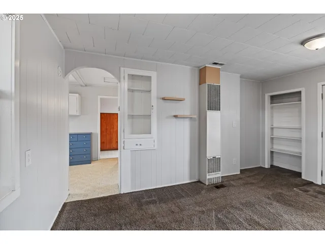 a kitchen with stainless steel appliances granite countertop a stove a sink and white cabinets