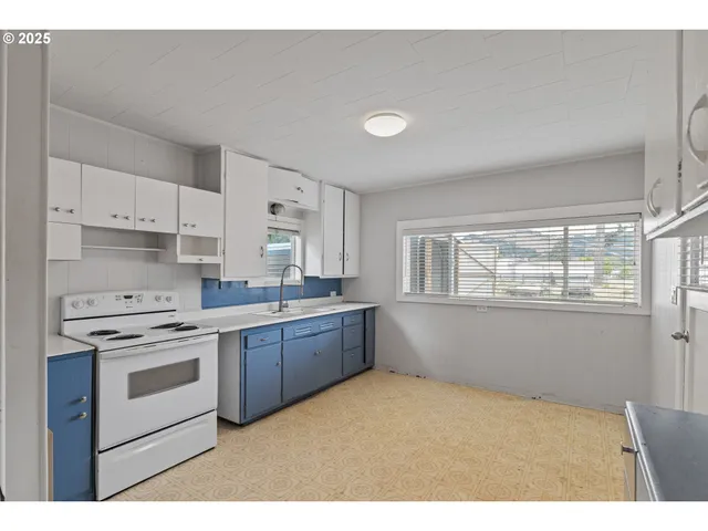 a kitchen with a sink stove and cabinets