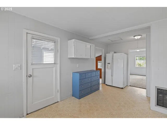 a kitchen with a sink window and cabinets
