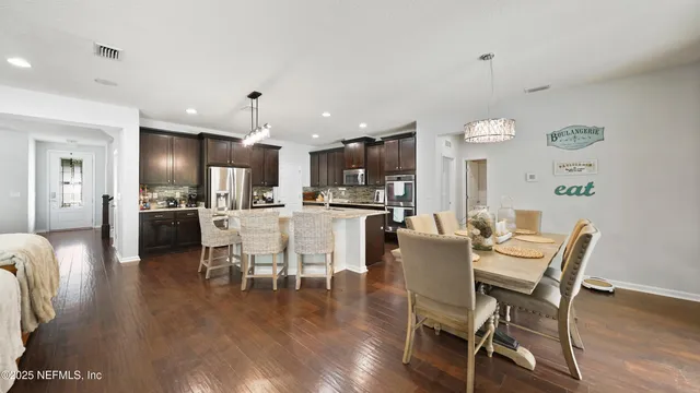 a kitchen with stainless steel appliances granite countertop sink stove top oven and cabinets