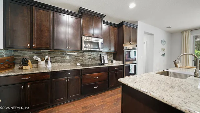 a living room with furniture a flat screen tv and a window