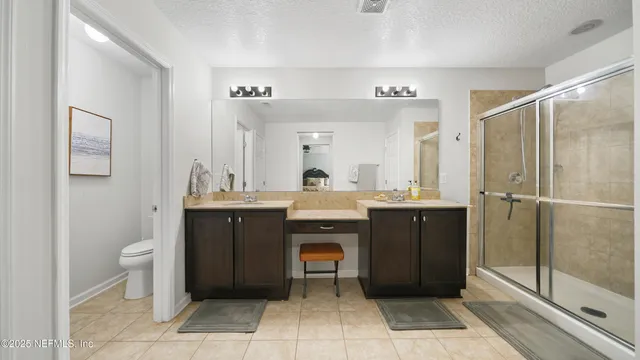 a bathroom with a sink a toilet and shower curtain