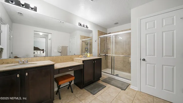 a view of walk in closet with clothes