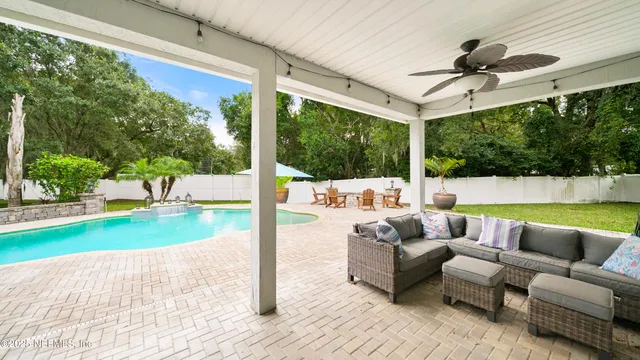 a view of a swimming pool and lounge chairs