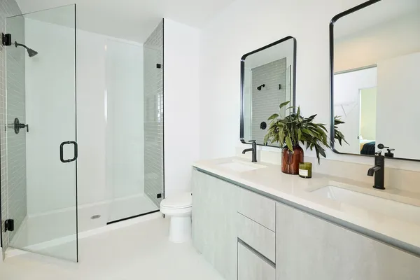 a bathroom with a shower sink and mirror