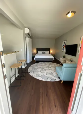 a room with a chair and a flat screen tv