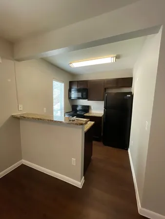 a kitchen with a refrigerator and a stove top oven
