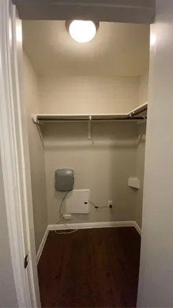 an empty room with a wooden floor and more cabinets