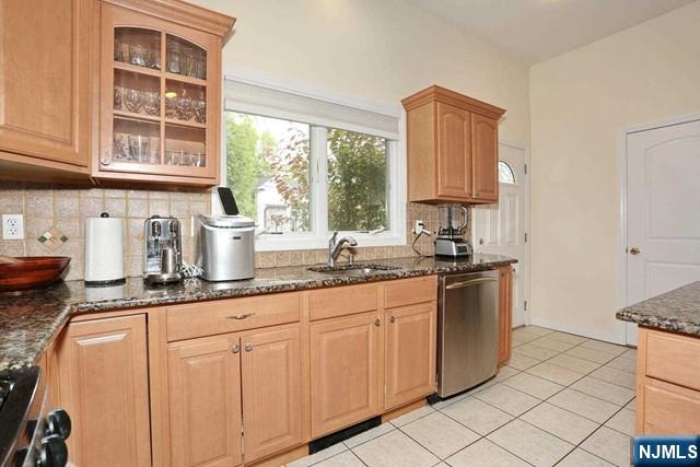 84 12th Street Cresskill, NJ 07626 - Photo 19 of 45 a kitchen with granite countertop white cabinets and a window