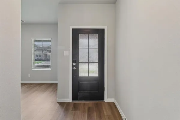 an empty room with windows and closet