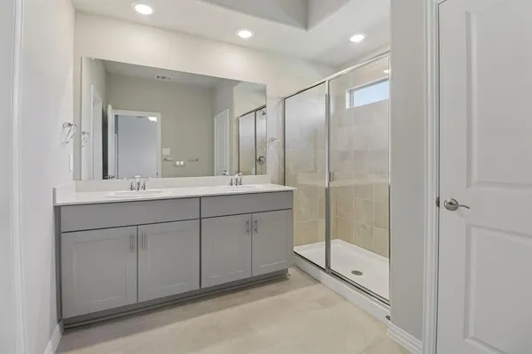a bathroom with a shower sink and mirror