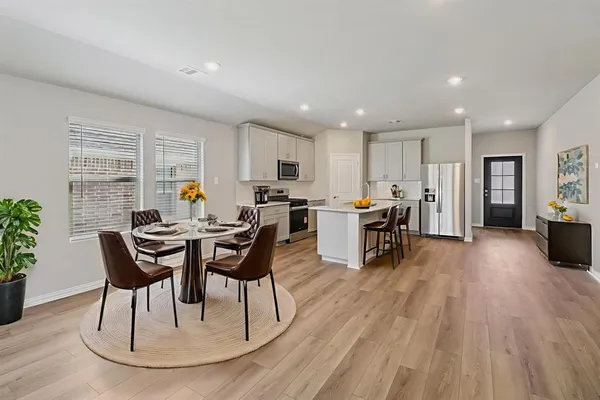 a view of a dining room with furniture and wooden floor