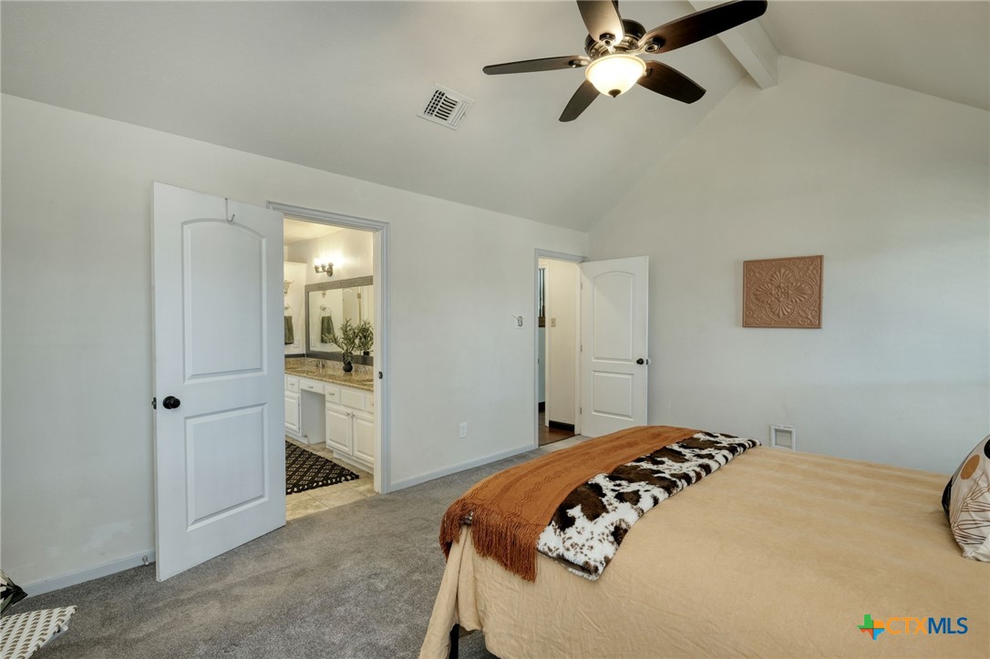 3403 Northwest Boulevard Georgetown, TX 78628 - Photo 12 of 28 a bedroom with a bed and a chandelier