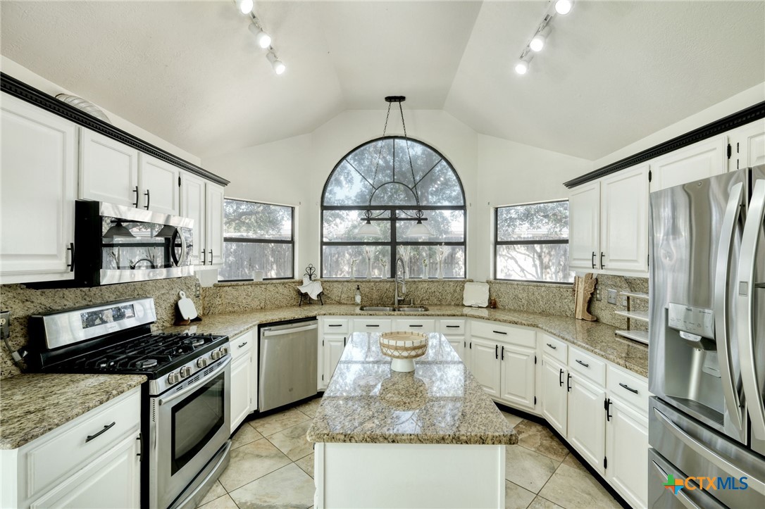 3403 Northwest Boulevard Georgetown, TX 78628 - Photo 8 of 28 a large kitchen with stainless steel appliances granite countertop a stove a sink and a granite counter tops
