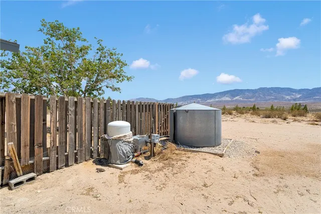 a view of a backyard with a chair and table