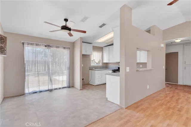 a view of a kitchen with a sink and a refrigerator