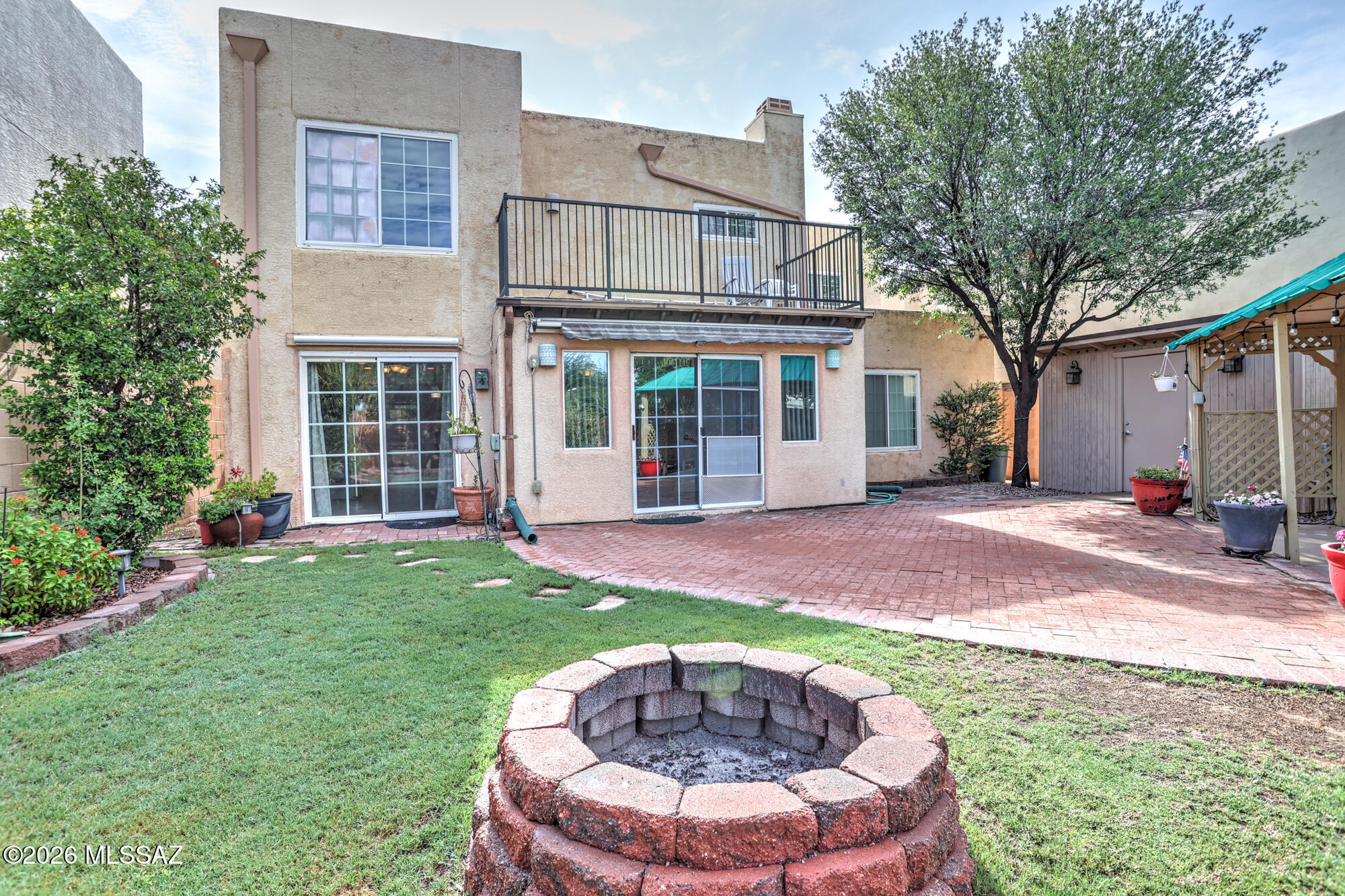 Rear yard with firepit. Gazebo on right.