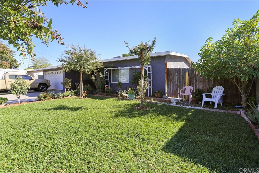 a front view of house with yard and outdoor seating