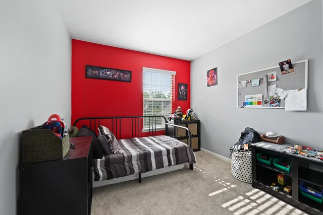 a bedroom with bed and a window