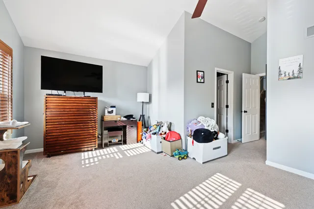 a bedroom with furniture and a flat screen tv