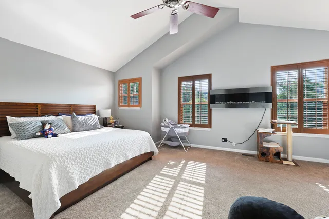 a bedroom with a bed and a large window