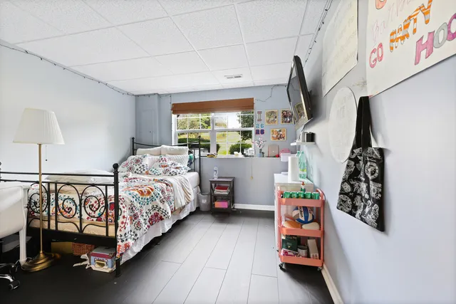 a bedroom with bed and a window