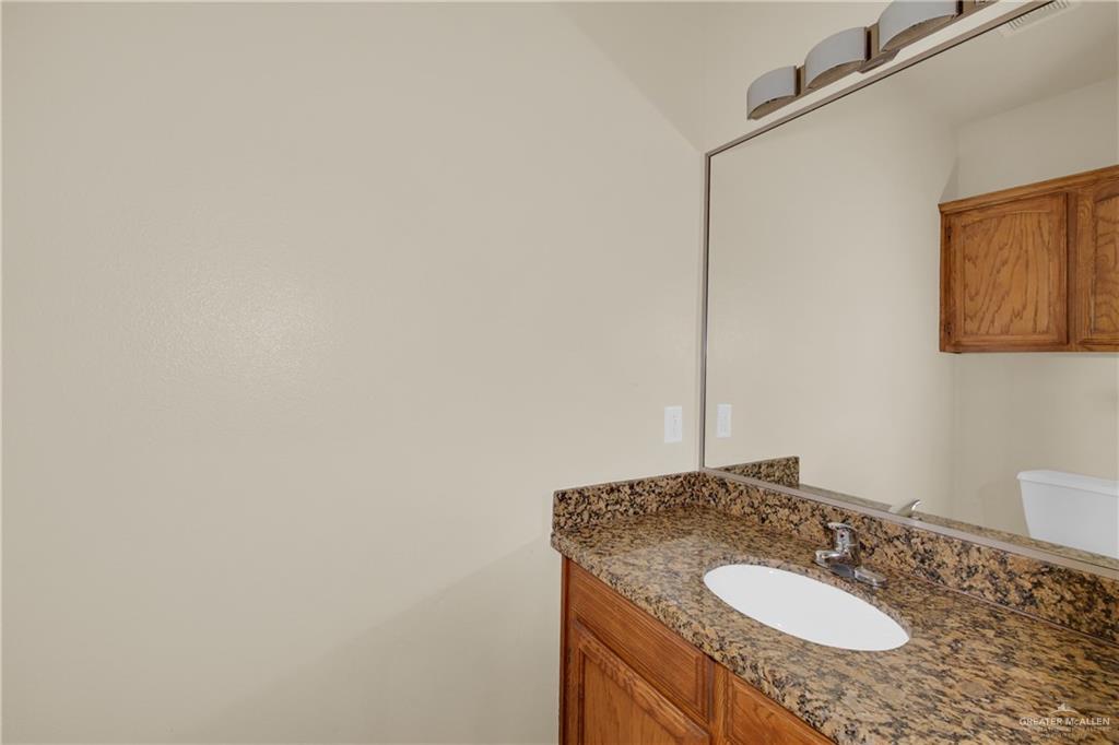 1814 East Iowa Road Edinburg, TX 78542 - Photo 13 of 22 a bathroom with a granite countertop sink and a mirror