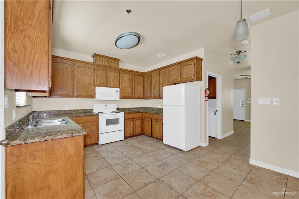 1814 East Iowa Road Edinburg, TX 78542 - Photo 3 of 22 a kitchen with a refrigerator sink and stove