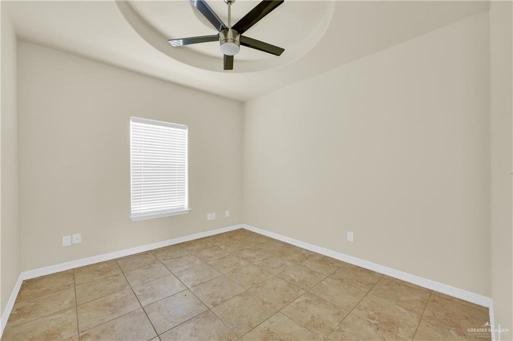 1814 East Iowa Road Edinburg, TX 78542 - Photo 5 of 22 an empty room with a window and a fan