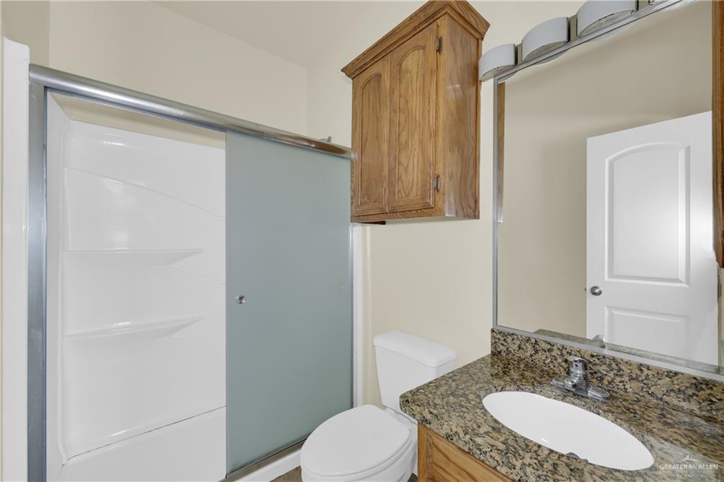 1814 East Iowa Road Edinburg, TX 78542 - Photo 6 of 22 a bathroom with a granite countertop sink and a mirror