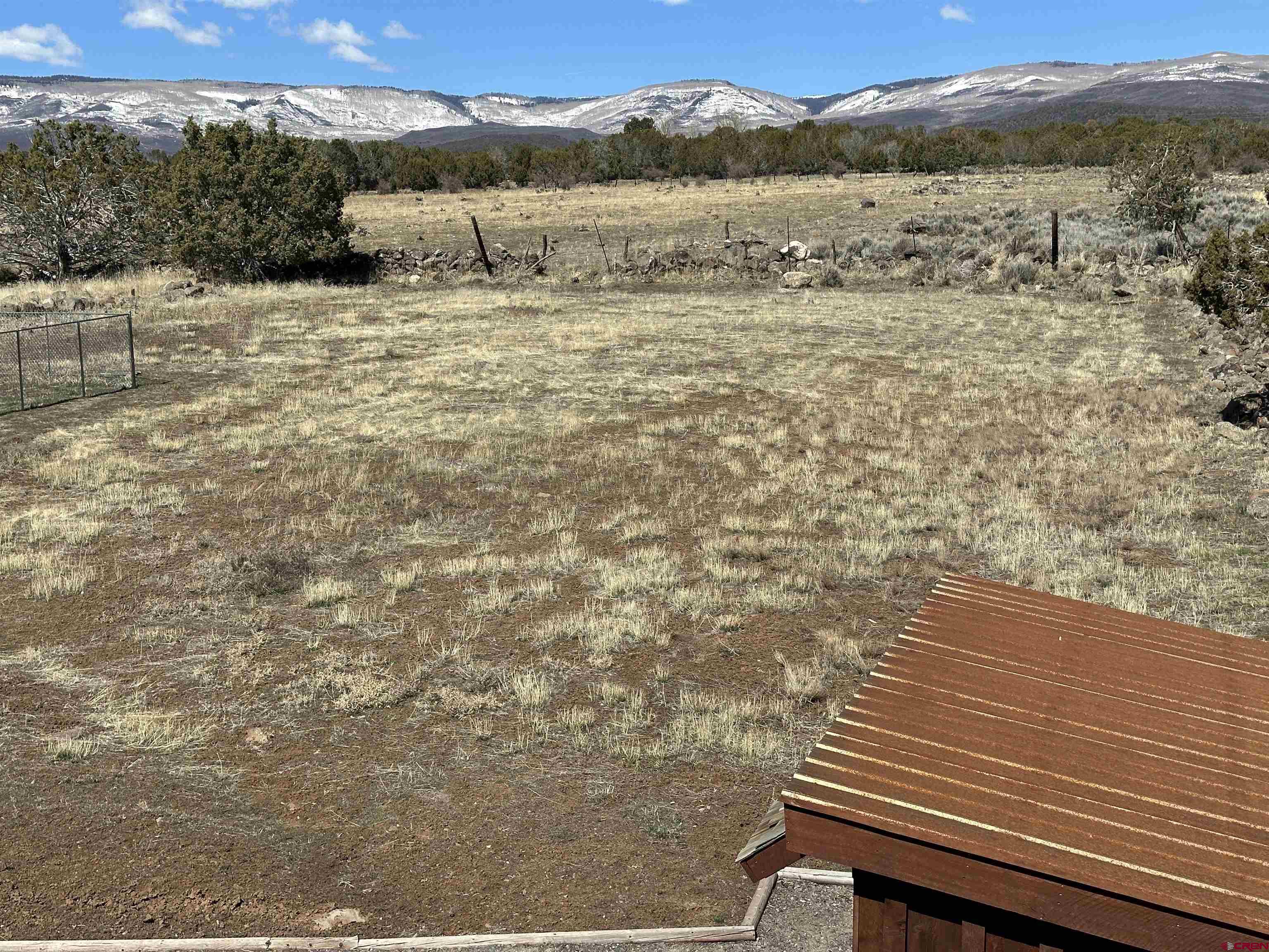 18180 Hanson Road Cedaredge, CO 81413 - Photo 16 of 34 a view of a yard with wooden fence