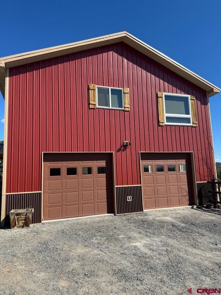 18180 Hanson Road Cedaredge, CO 81413 - Photo 29 of 34 a front view of a house with a yard and garage