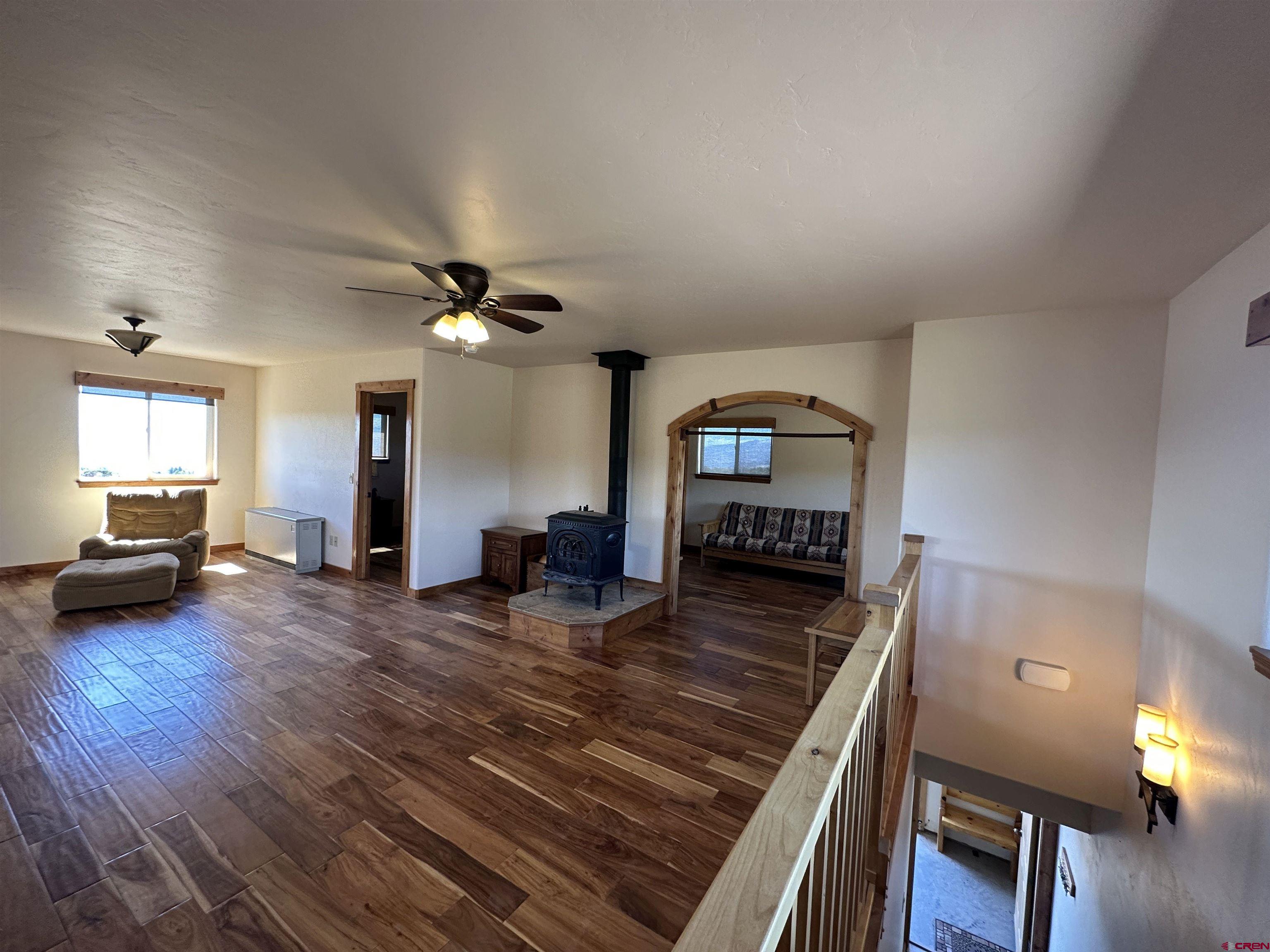 18180 Hanson Road Cedaredge, CO 81413 - Photo 7 of 34 a living room with furniture and a wooden floor