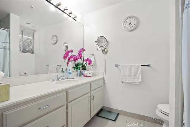 a bathroom with a sink mirror and vanity