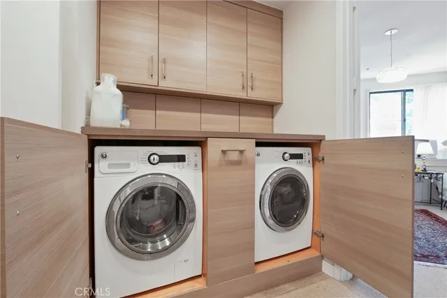 a utility room with sink dryer and washer