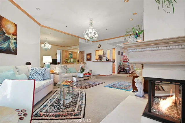 a living room with furniture and a chandelier