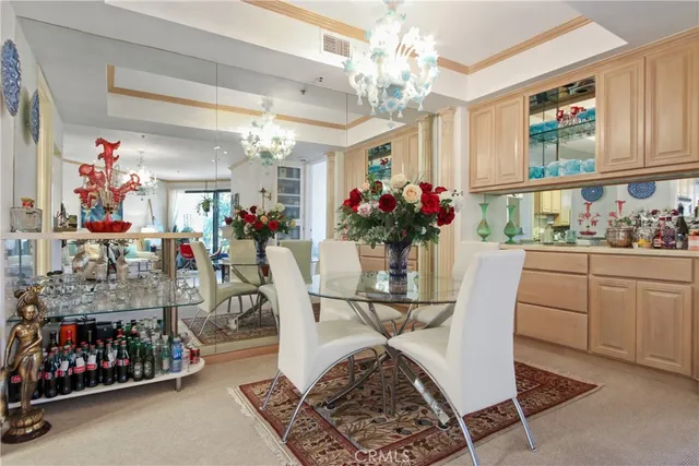 a view of a dining room with furniture and chandelier