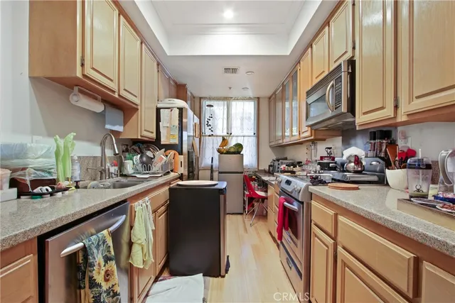 a kitchen with stainless steel appliances granite countertop a sink stove and cabinets