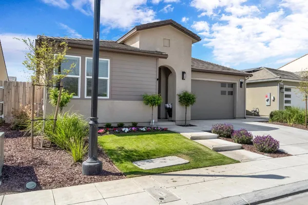 a view of a house with backyard and sitting area