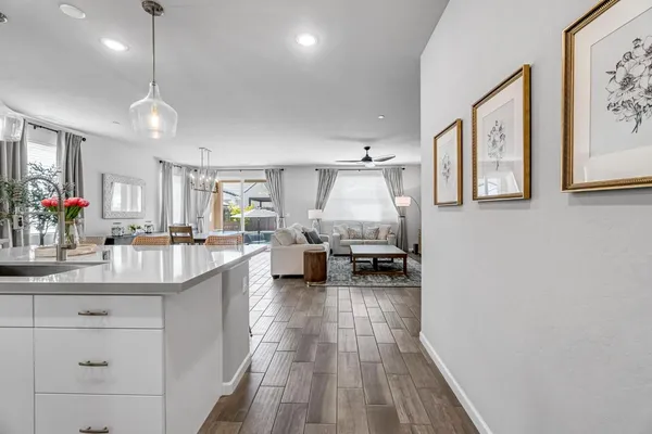 a living room with furniture and kitchen view