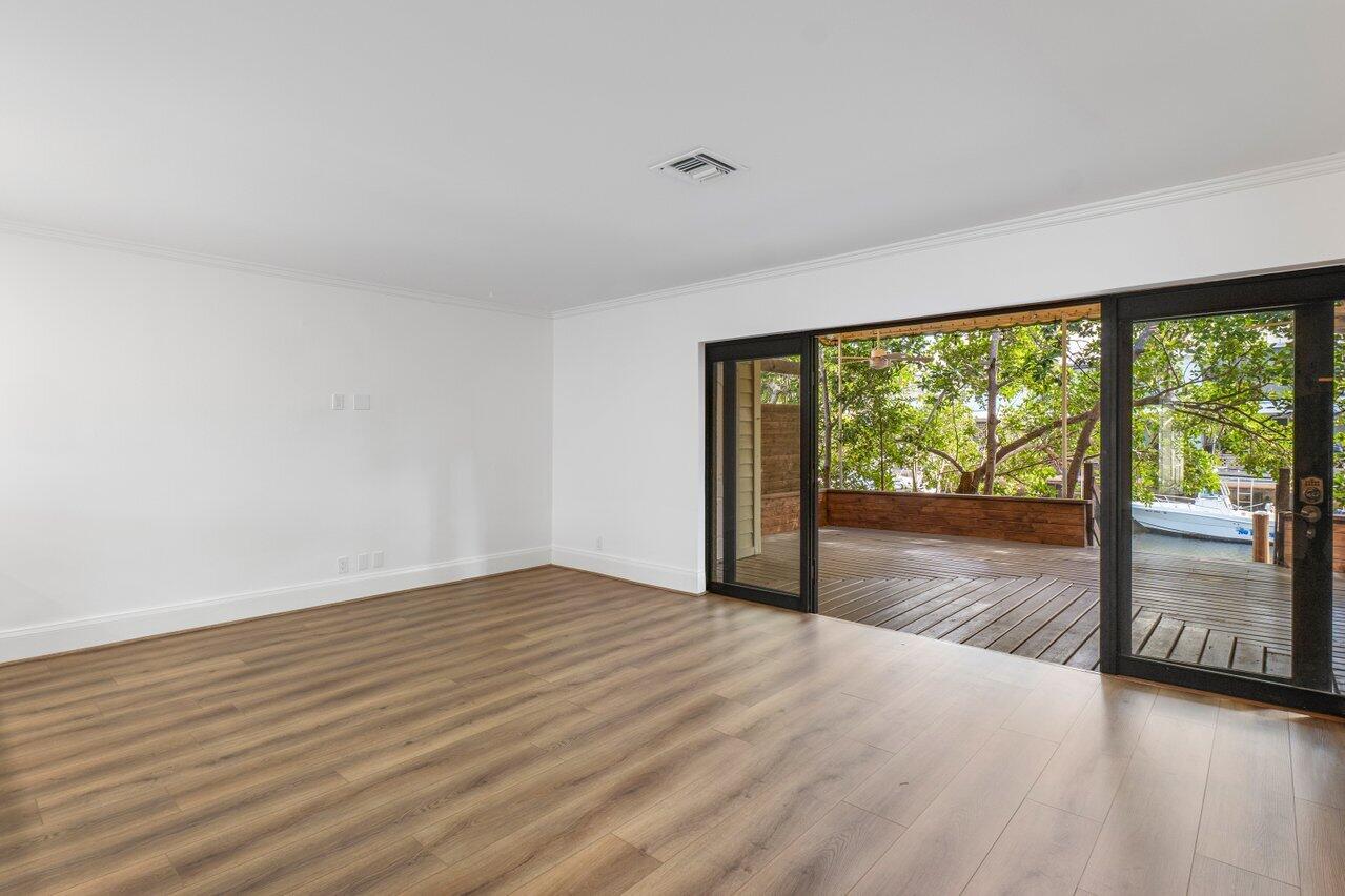 720 Mariners Way Boynton Beach, FL 33435 - Photo 12 of 49 a view of an empty room with wooden floor and a window