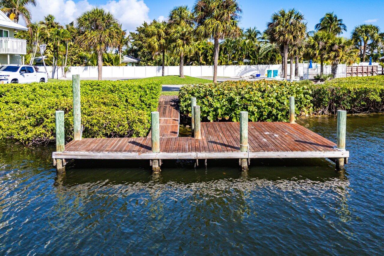 720 Mariners Way Boynton Beach, FL 33435 - Photo 21 of 49 a view of a wooden deck with a bench